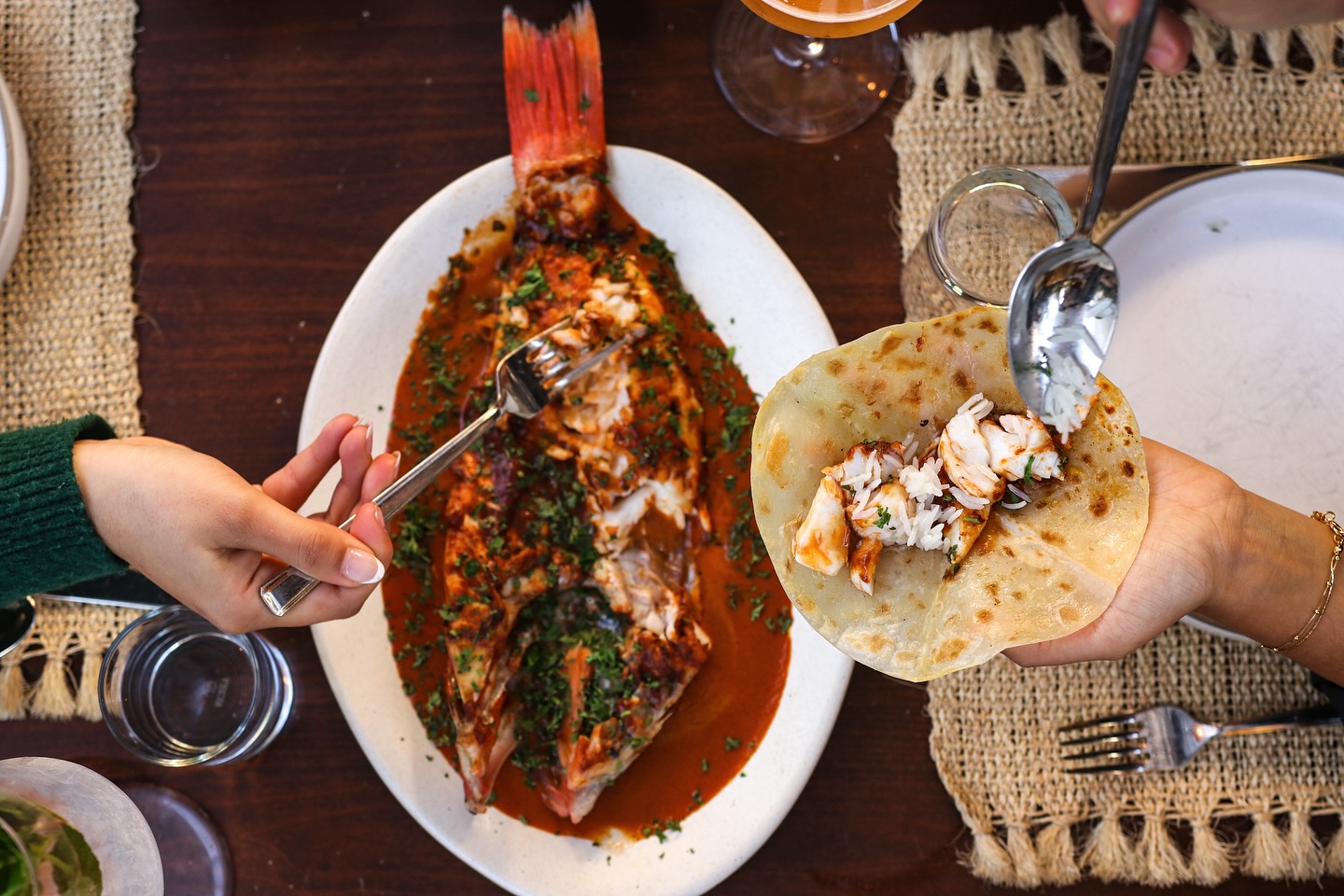 A whole fish being assembled into tacos.