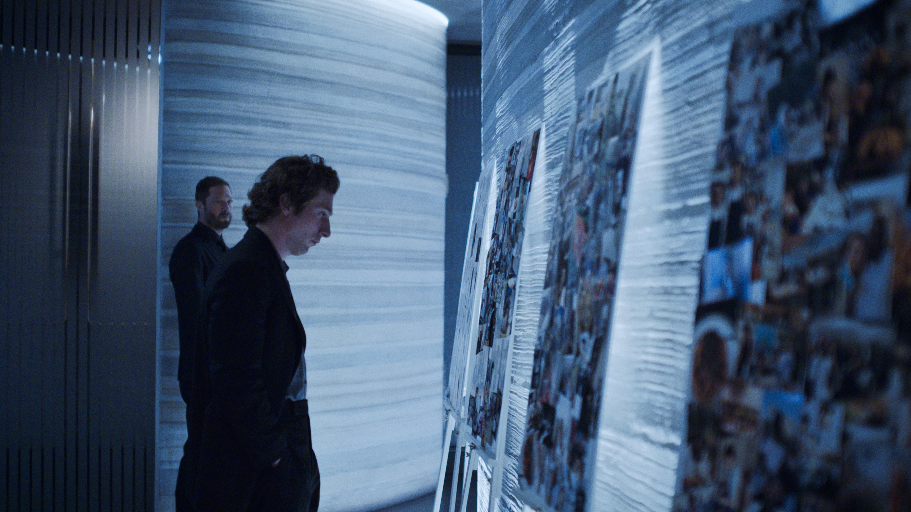 Jeremy Allen White as Carmy Berzatto in The Bear, gazing at a steely collage of photos