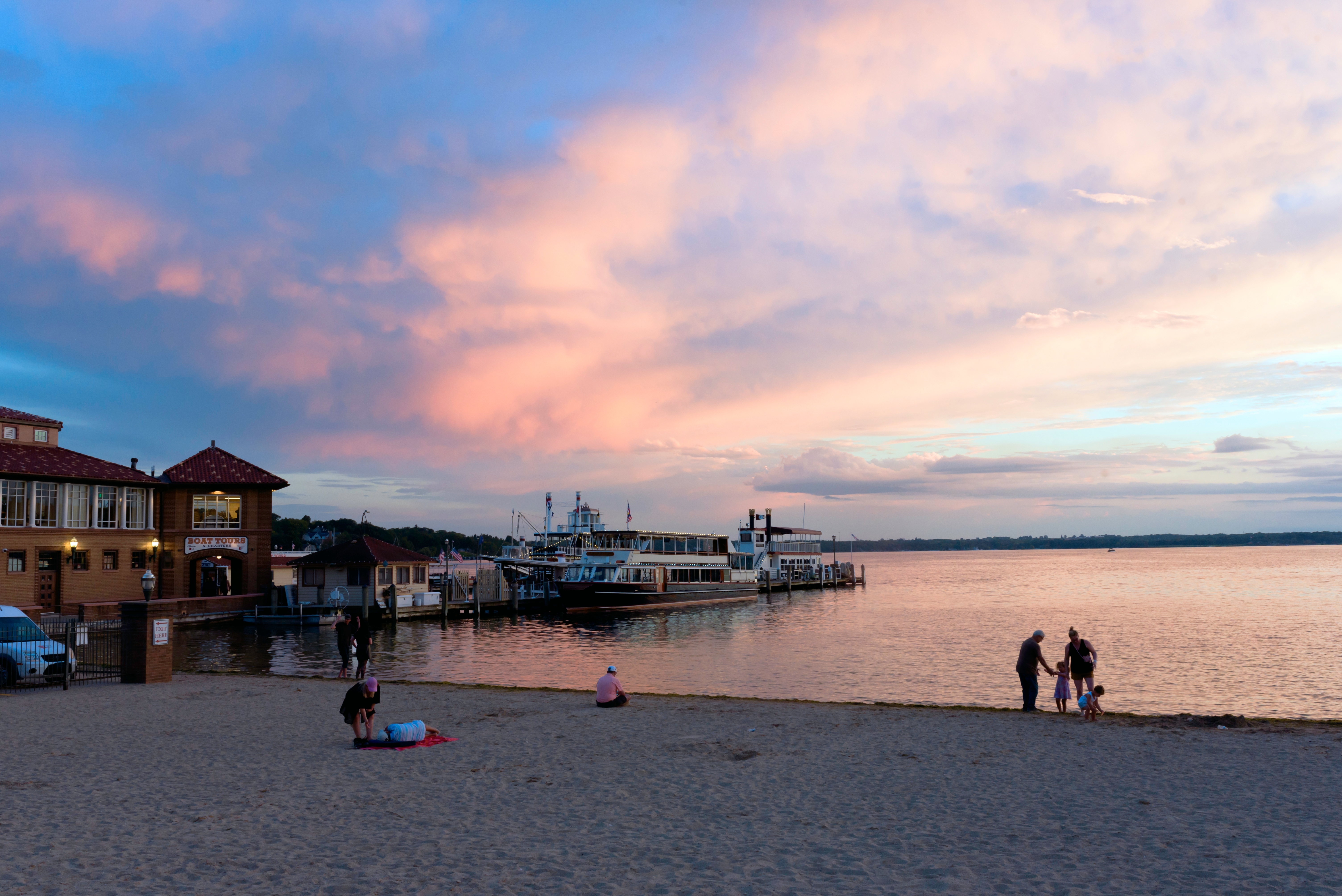 A beachside building on Lake Geneva at sunset.